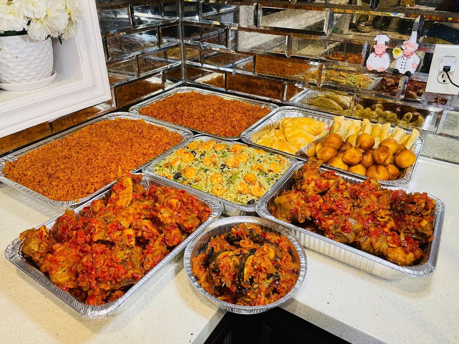 Jannah Grills catering trays — party jollof, fried rice, peppered chicken, fish and small chops in family serving trays